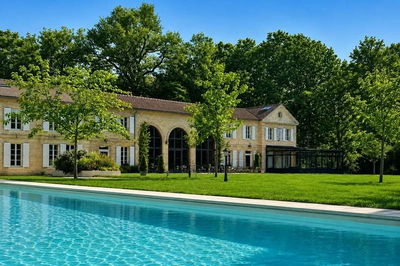 The château’s long wing and its pool on a summer morning