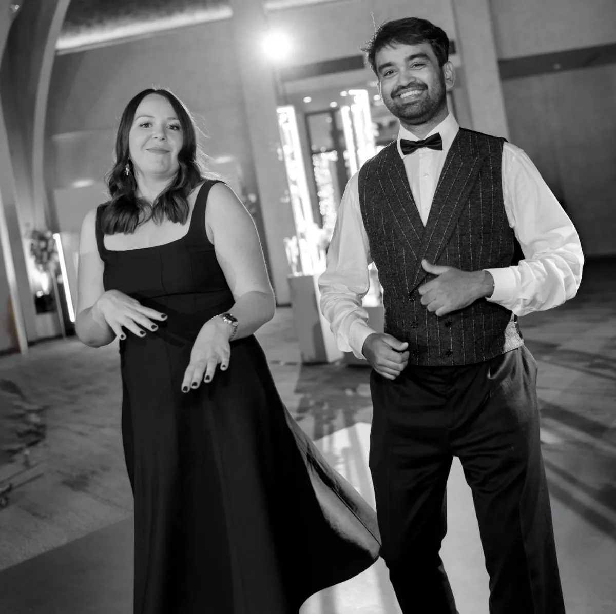 Adeline and Anirban dancing, laughing, in black and white